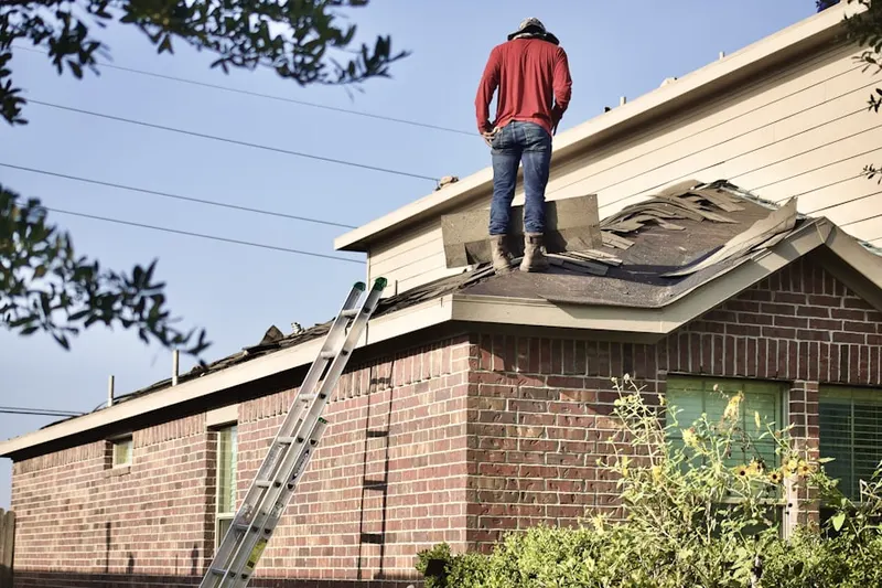 Professional roofer working on a residential roof in Presidential Lake Estates